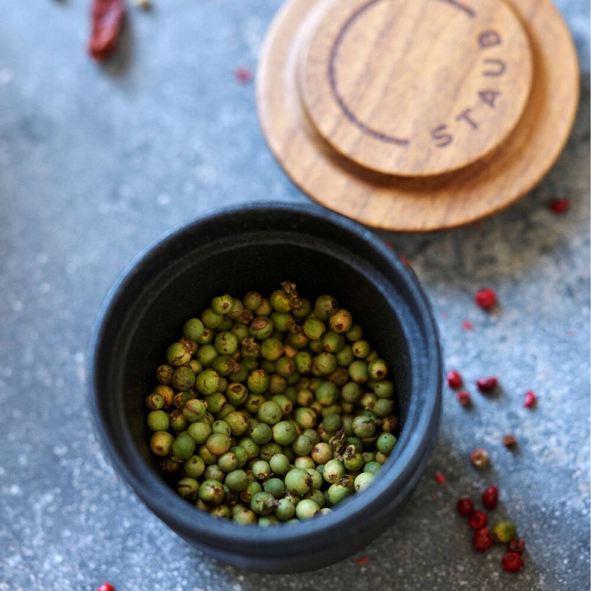 green peppercorns in spice grinder