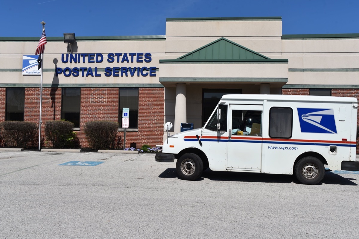 King of Prussia, PA/USA-April 7, 2020: United States Post Office truck parks outside the post office building to pick up mail during the COVID-19 virus, since they are considered essential business.