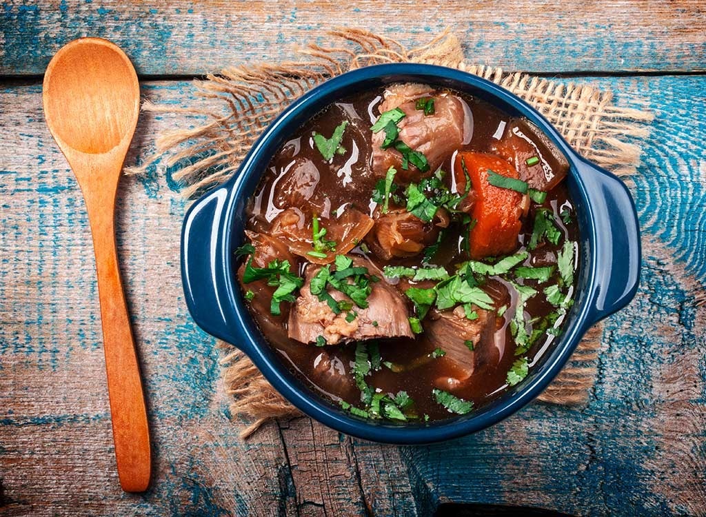 bowl of stew with wooden spoon