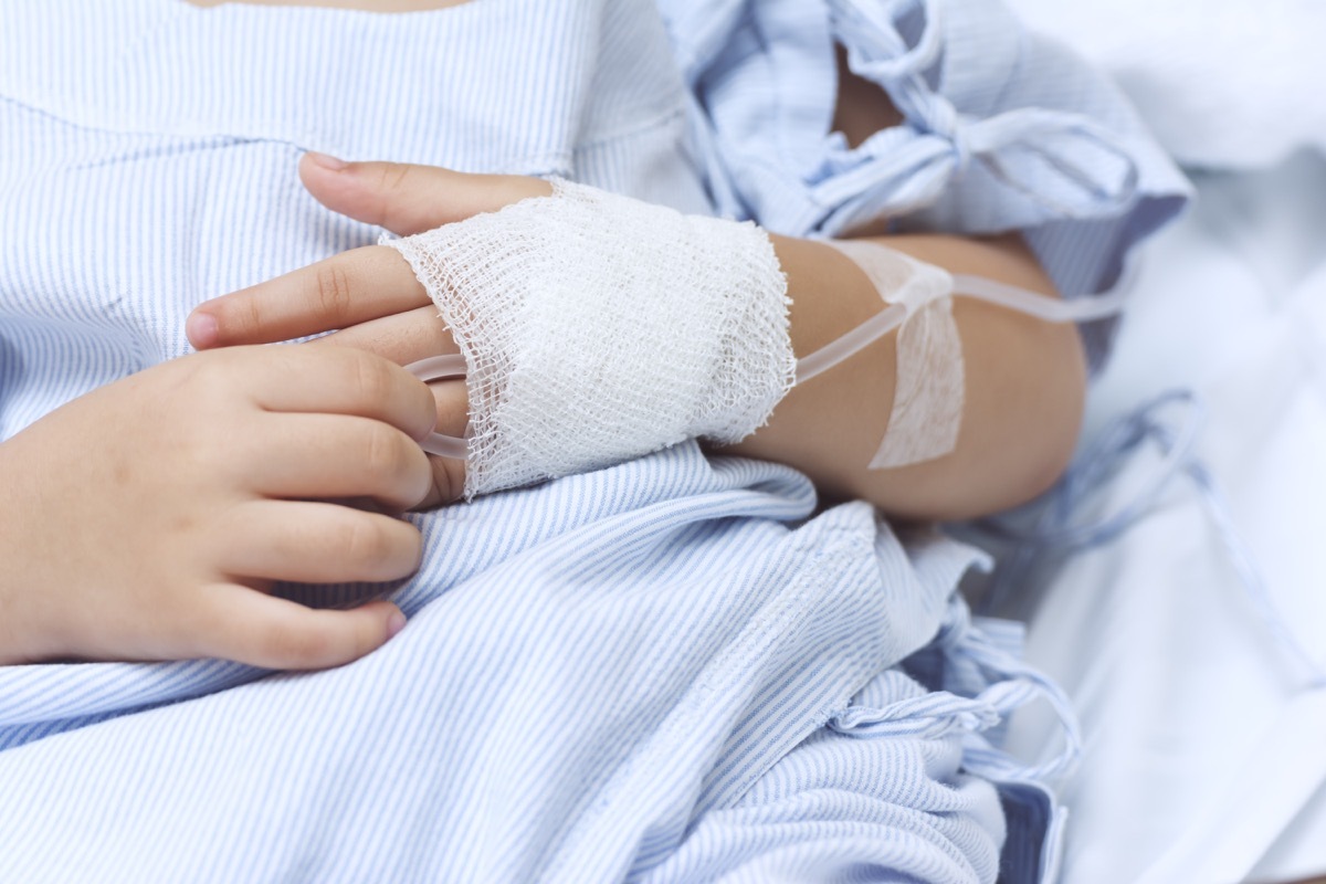 Hand of the sick child with saline solution with Space for text.