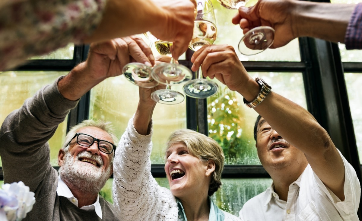 group of older adults drinking a champagne toast