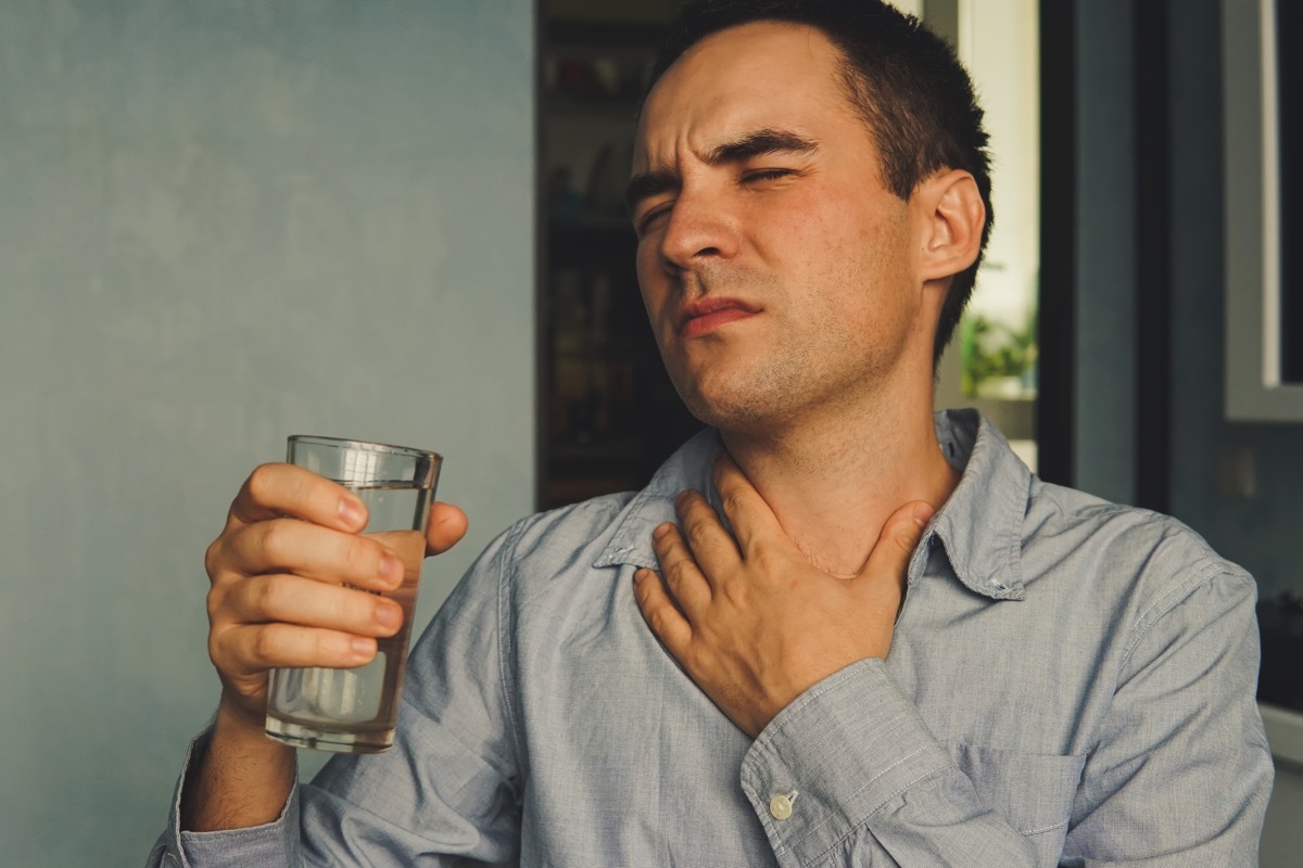 Man drinking water to cure dry throat