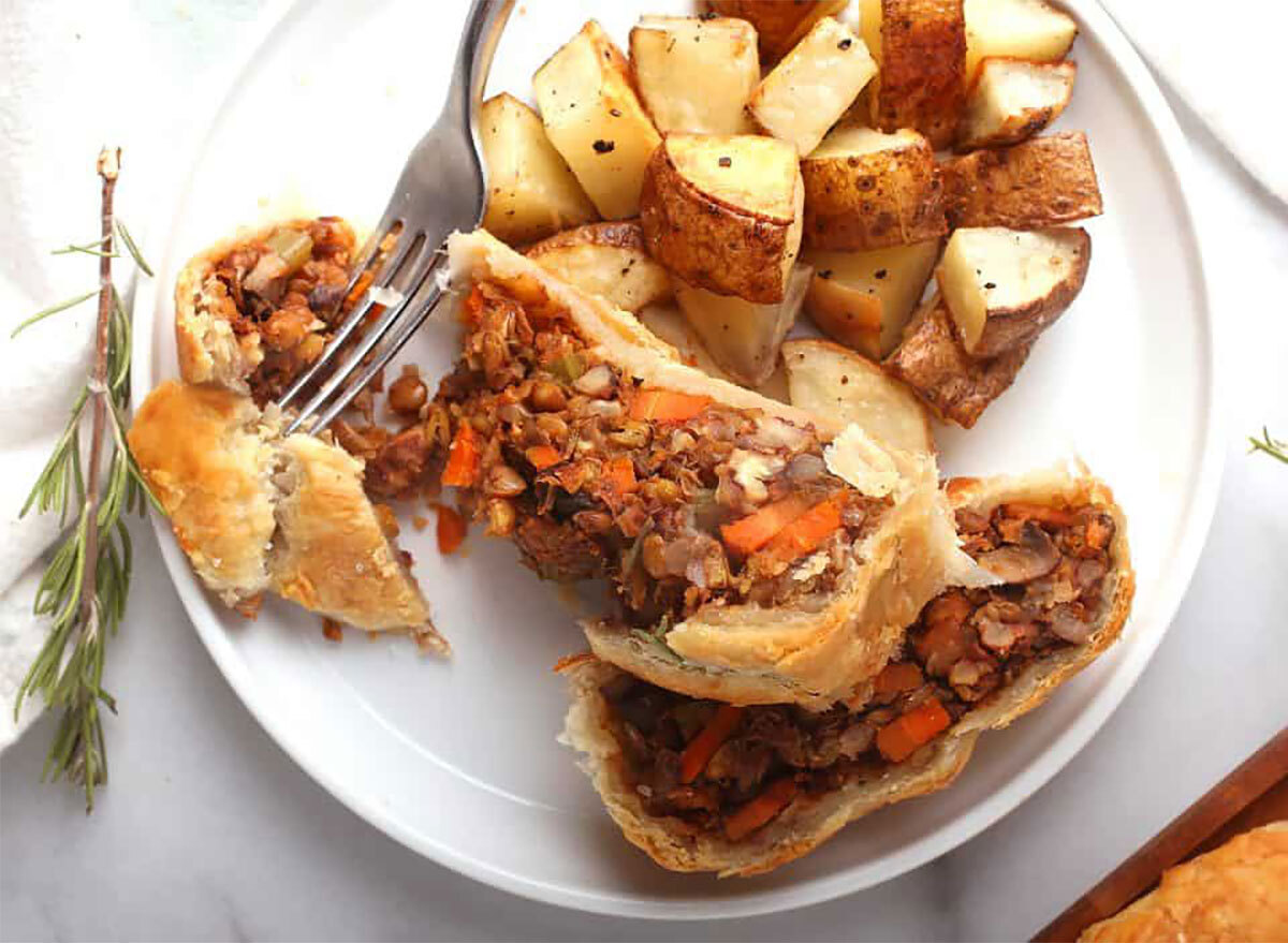 vegan beef wellington with roasted potatoes on plate