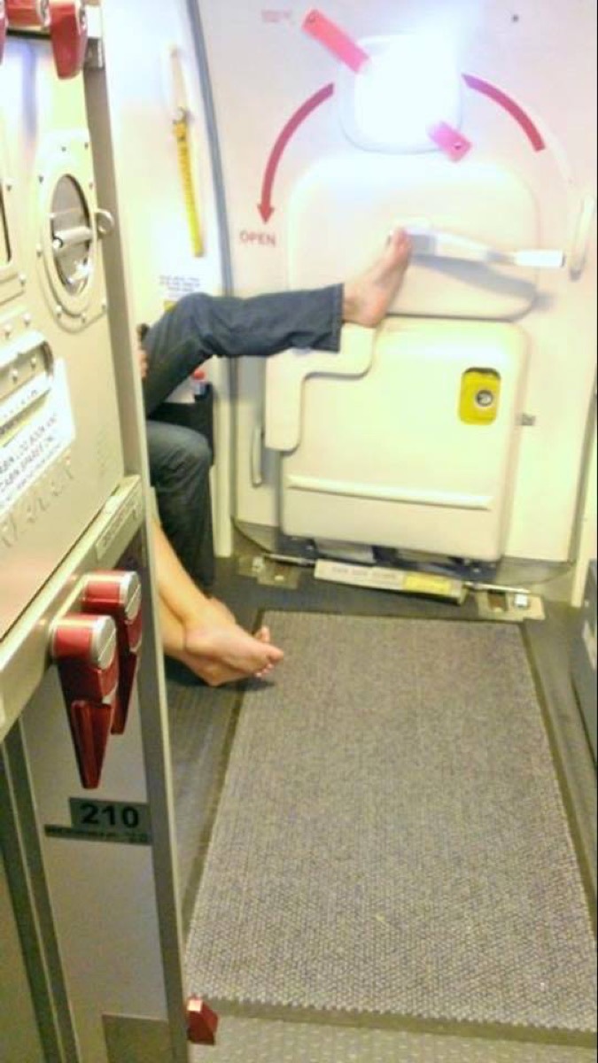 Airline passenger touching handle with foot photos of terrible airplane passengers