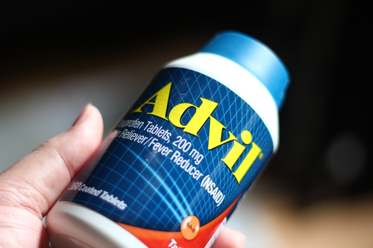 holding a bottle of advil