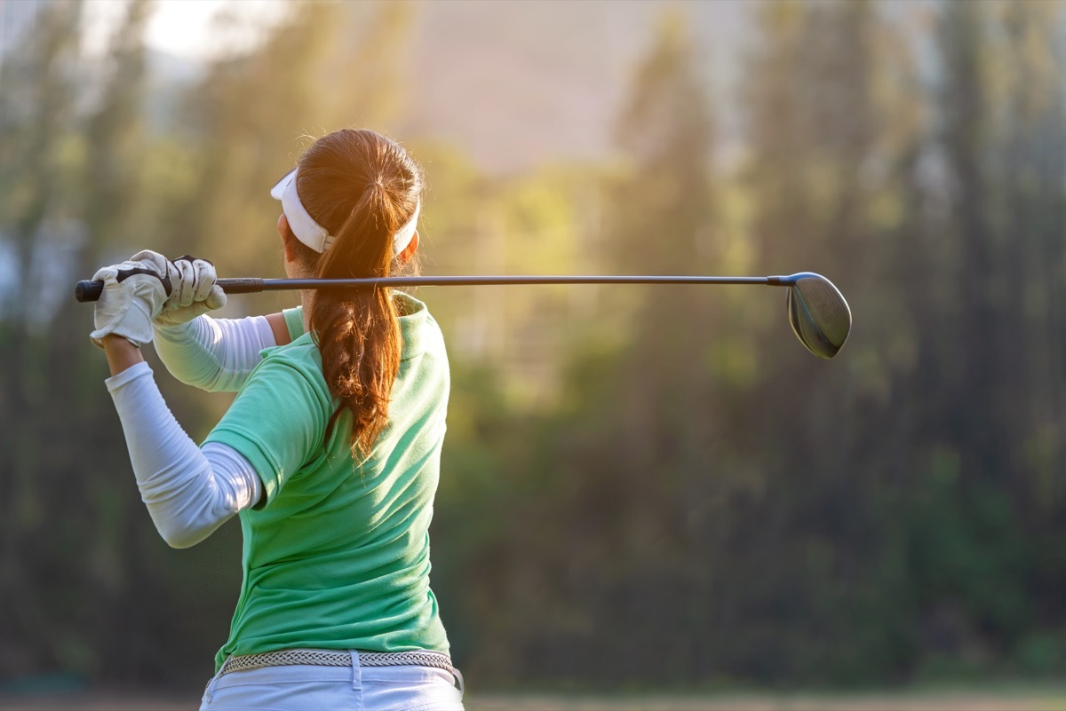 Woman golfing