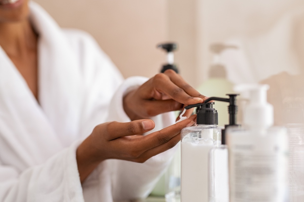 Woman putting moisturizer on hands