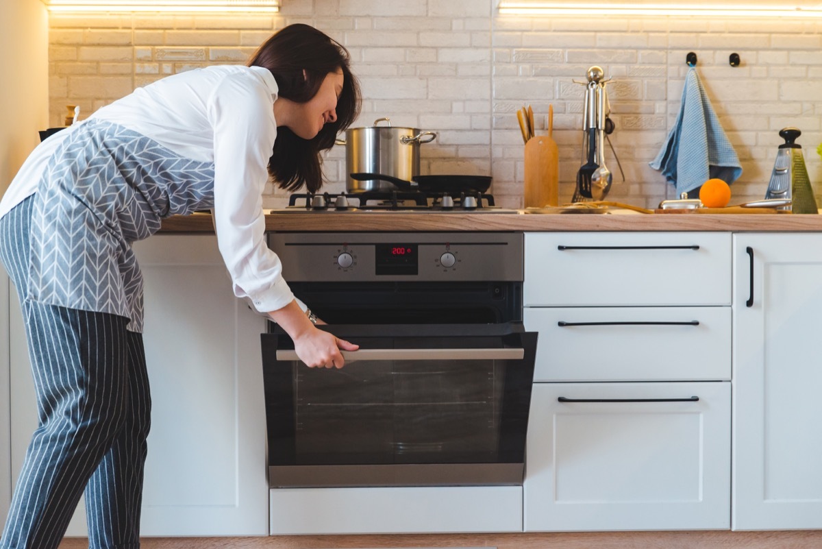 Woman using oven to cook