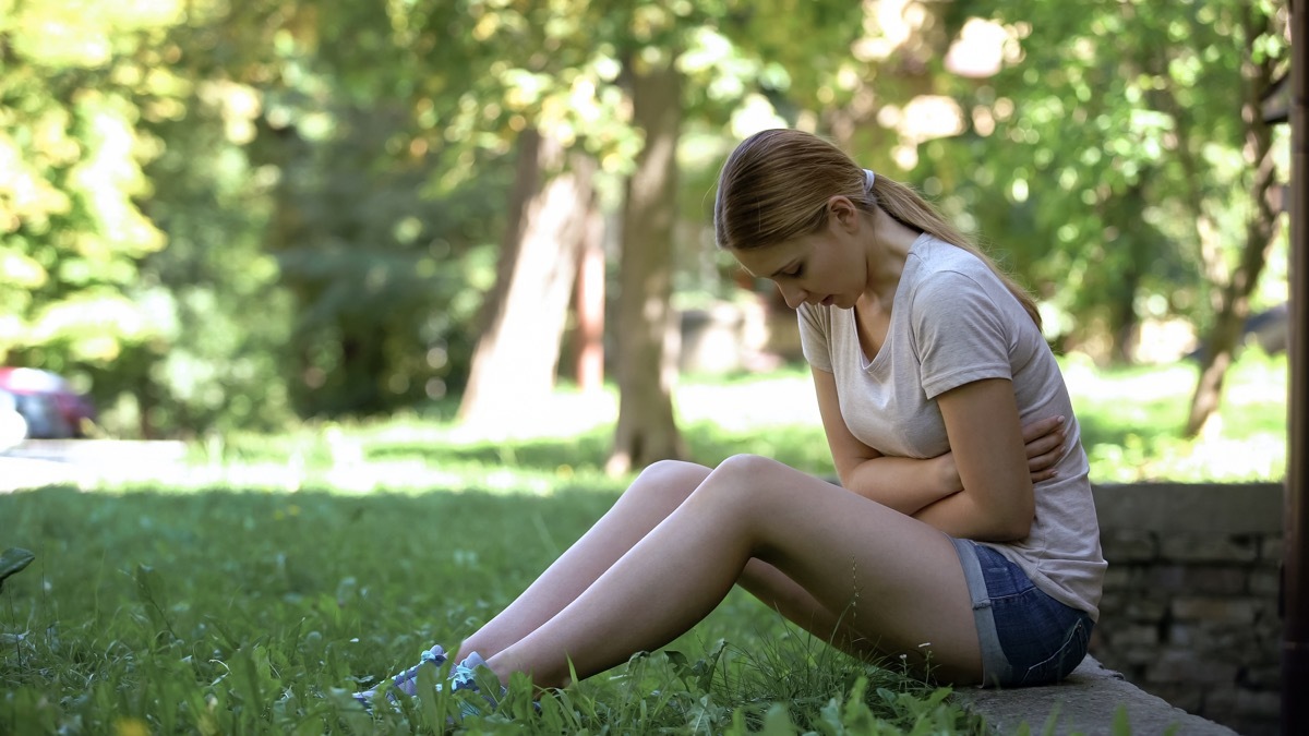 Girl Sitting on the Floor with Pain in her Side {Pain in Your Side}