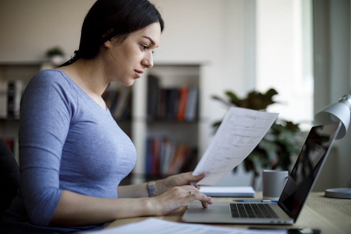 Serious young woman working at home