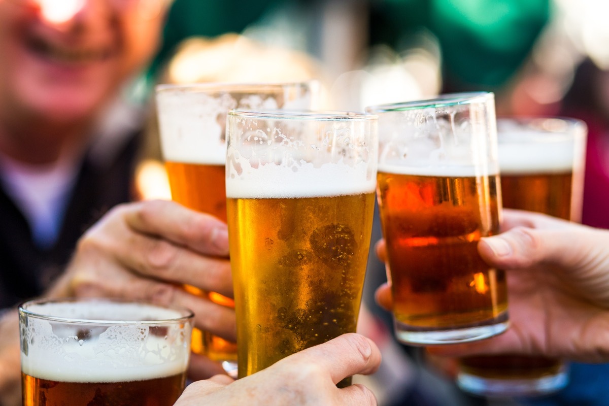 people holding glasses of beer together