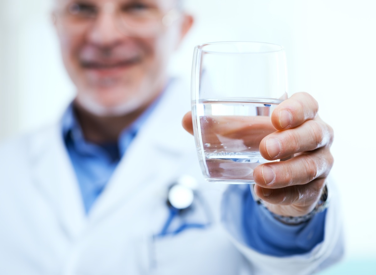 Doctor offering a glass of water