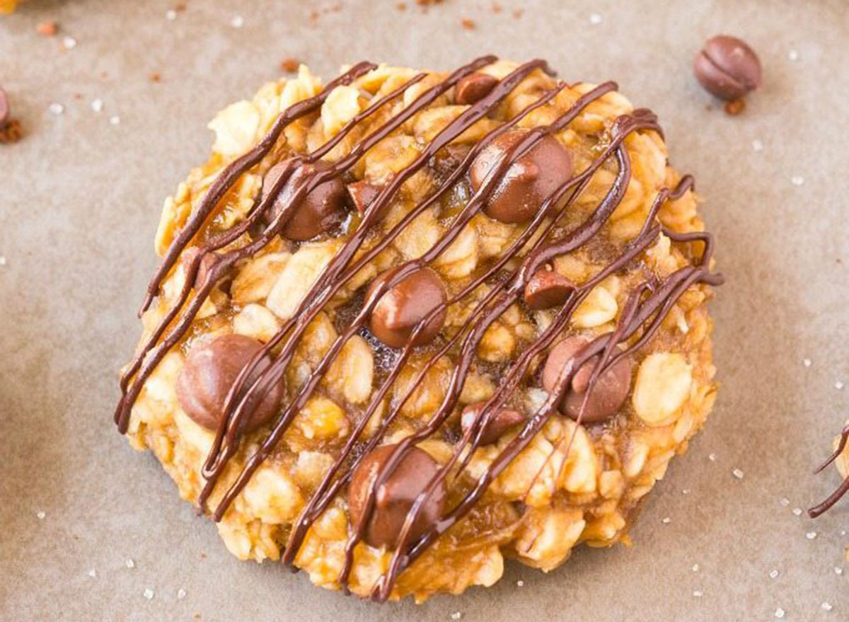 Banana bread oat cookie on a counter with chocolate drizzle