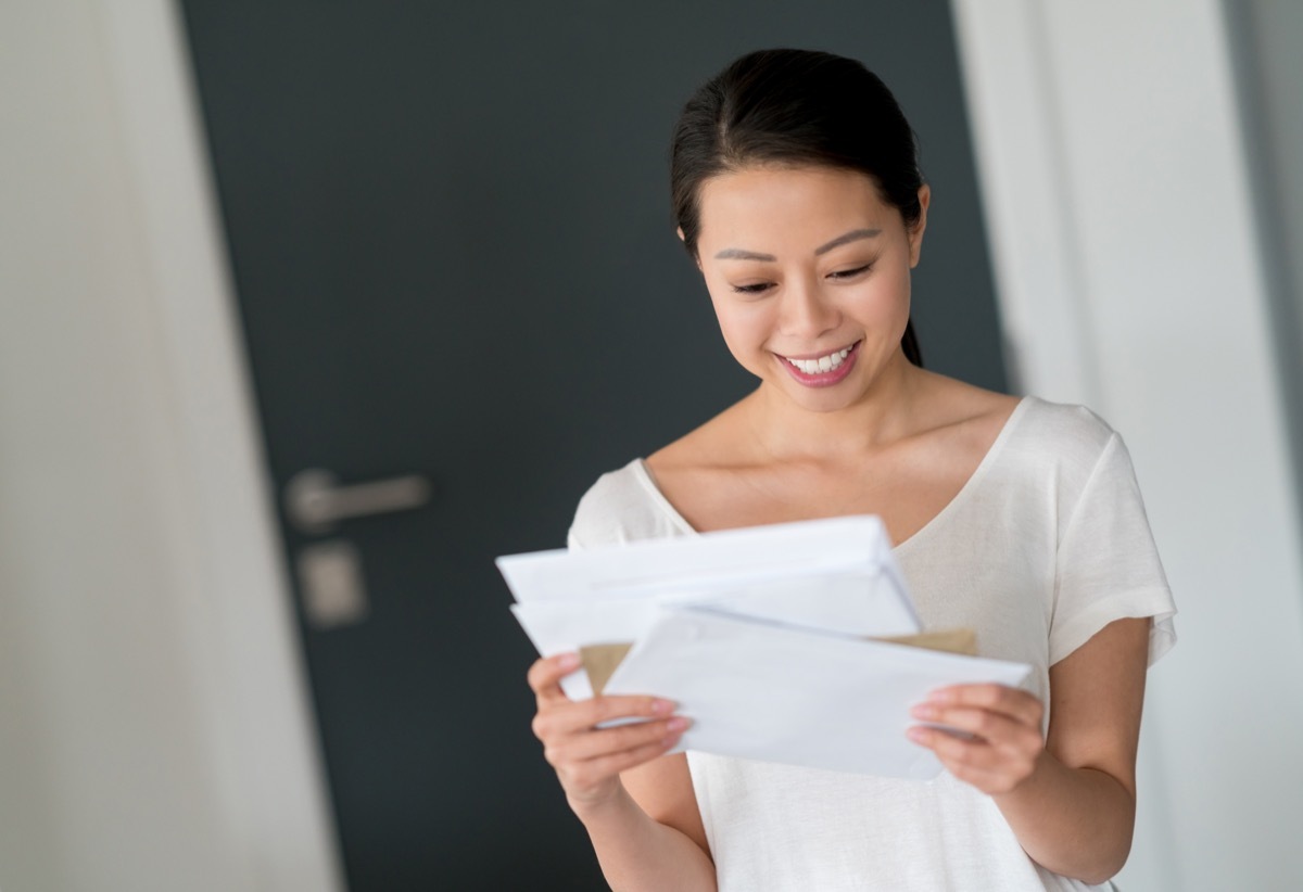 woman at home checking her mail and looking very happy - lifestyle concepts