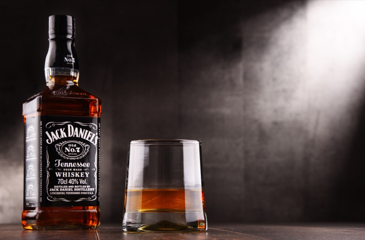 Jack Daniel's and glass in front of a grey background