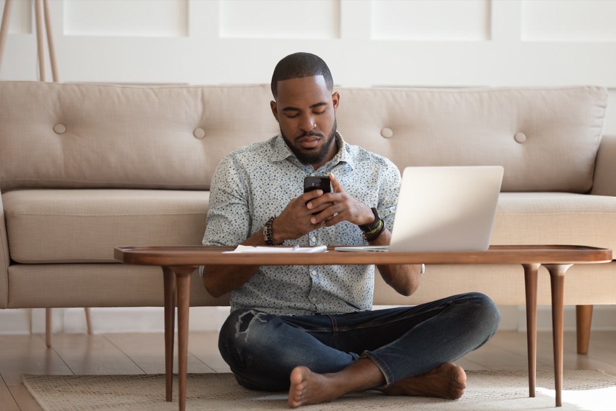 Man sitting on floor at home during pandemic