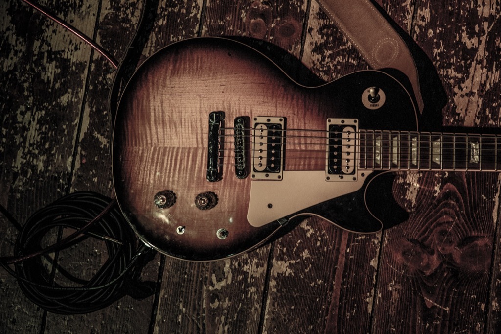 vintage gibson les paul on a beat up wooden stage