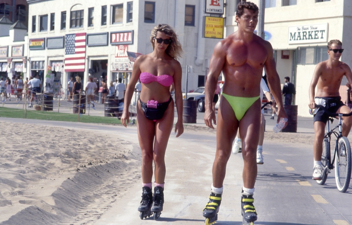 Couple rollerblading in neon in Venice Beach, California circa the 1980s.