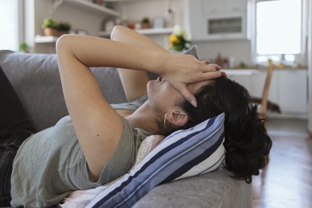 Tired woman holding her head with her hands.