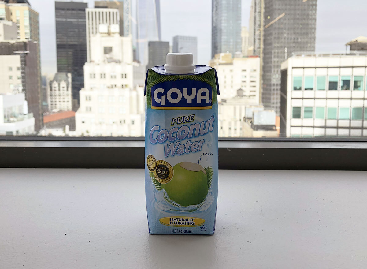 goya pure coconut water bottle in front of window