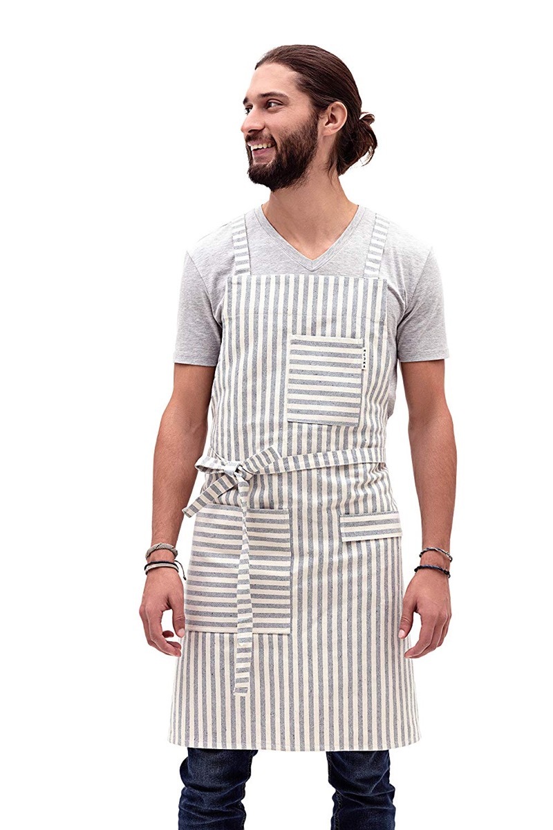 white guy with man bun in gray and white striped apron