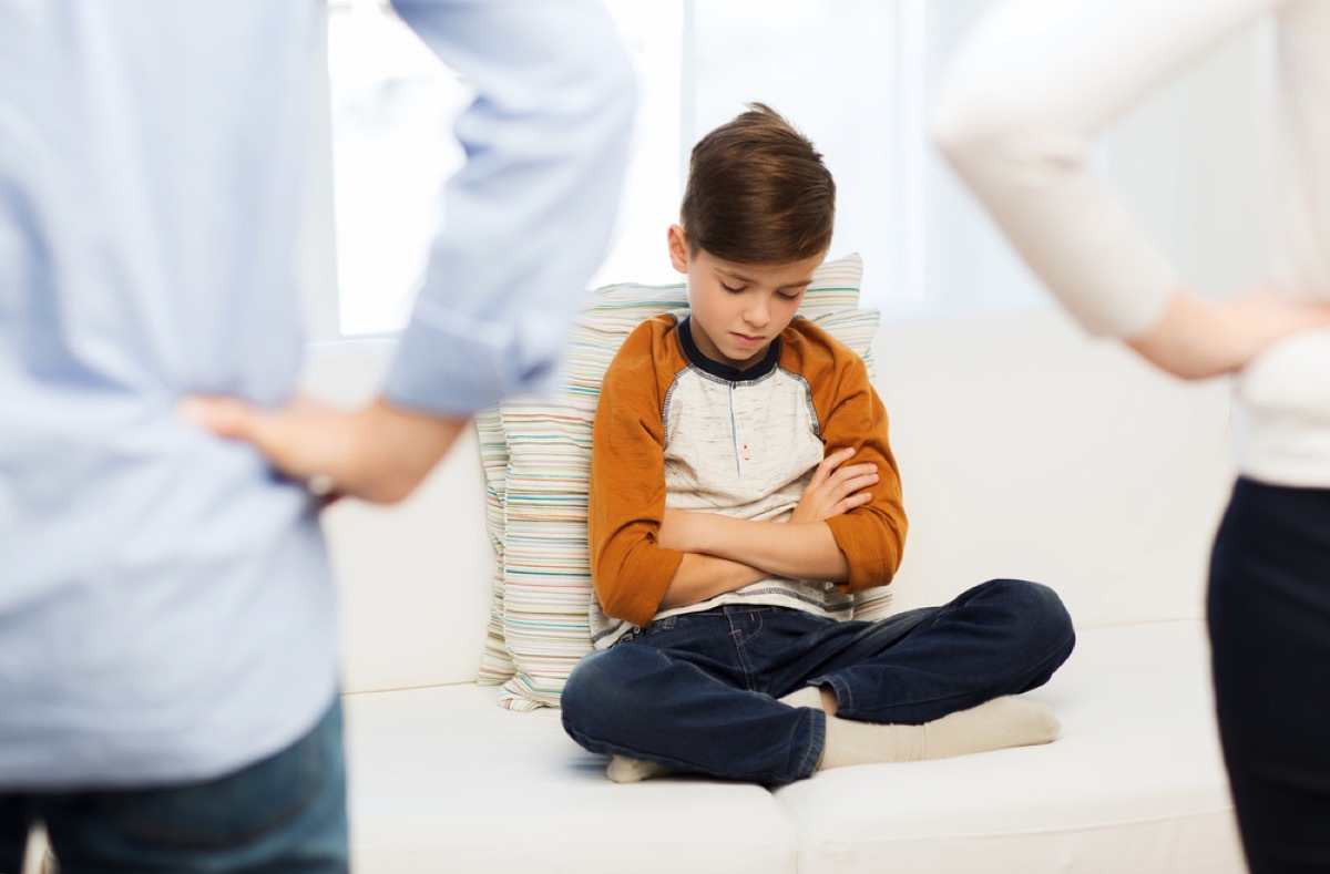 parents looking at son sitting on couch, prepare children for divorce