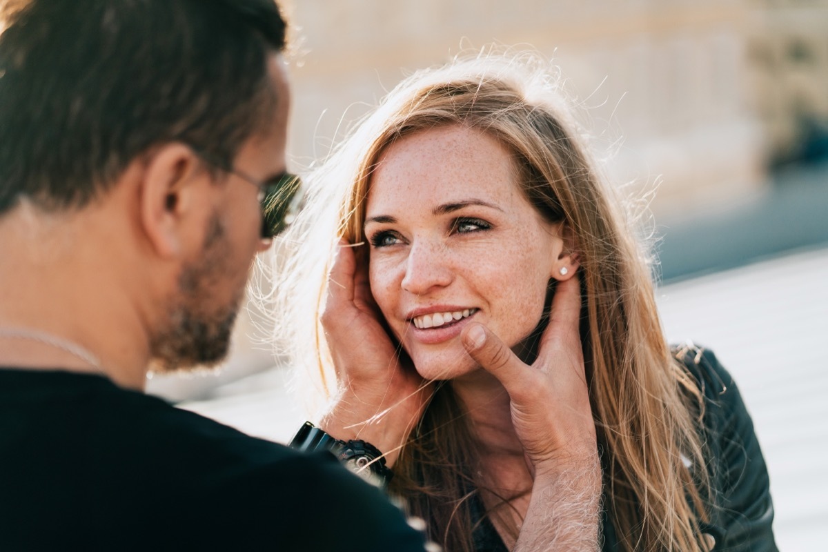 Man looking at his girlfriend and touching her face