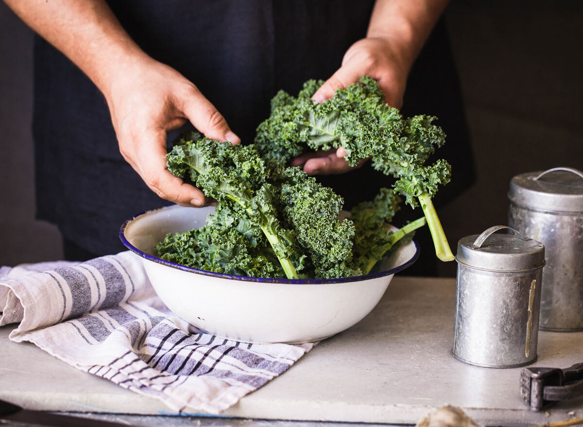 Kale dark leafy greens hand massaged in bowl - calcium rich foods