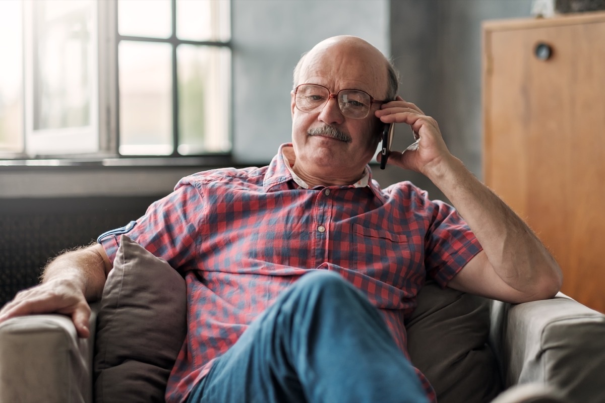 talking on phone sitting at living room. Discuss important questions.