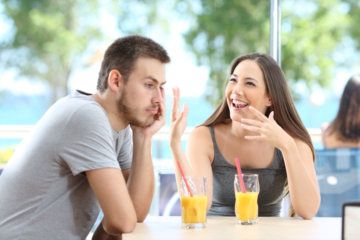 Bored man listening to friend talking 