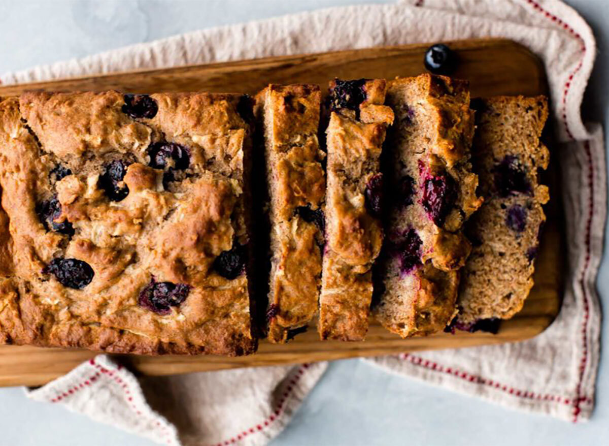 sliced loaf of blueberry bread on wooden board