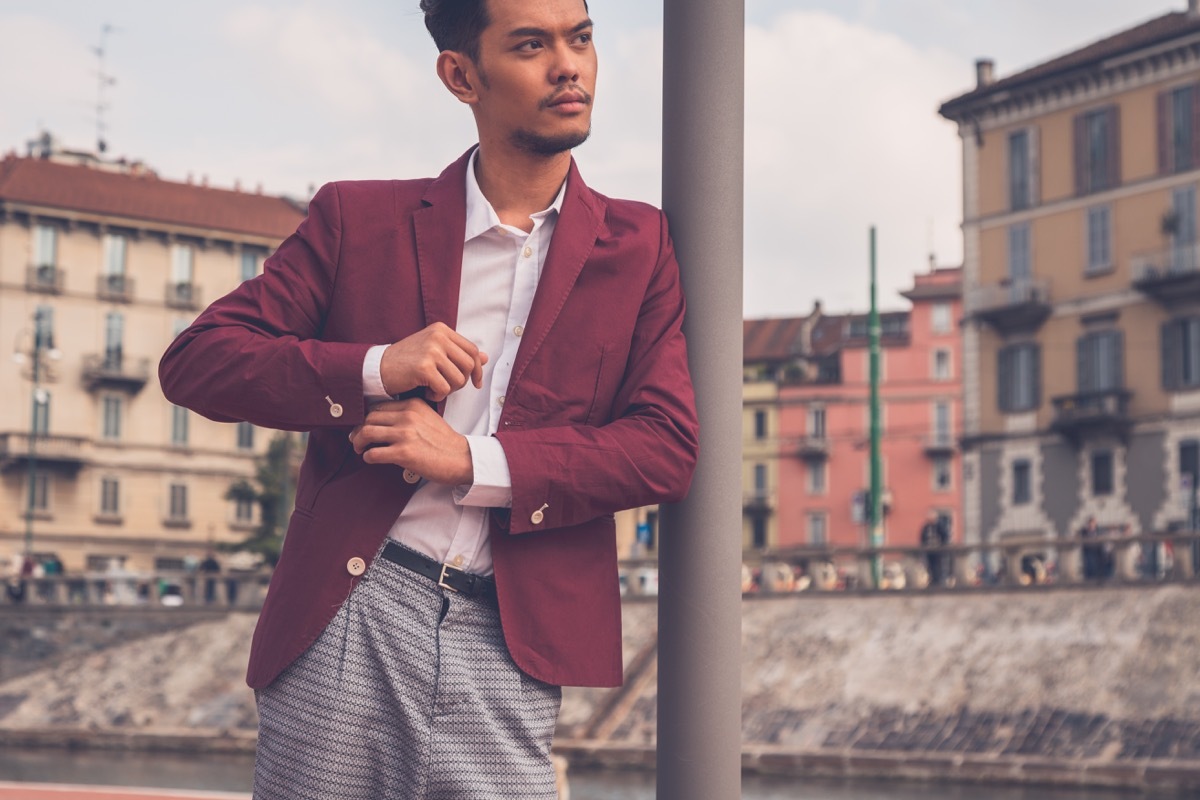 man wearing a red blazer and plaid pants