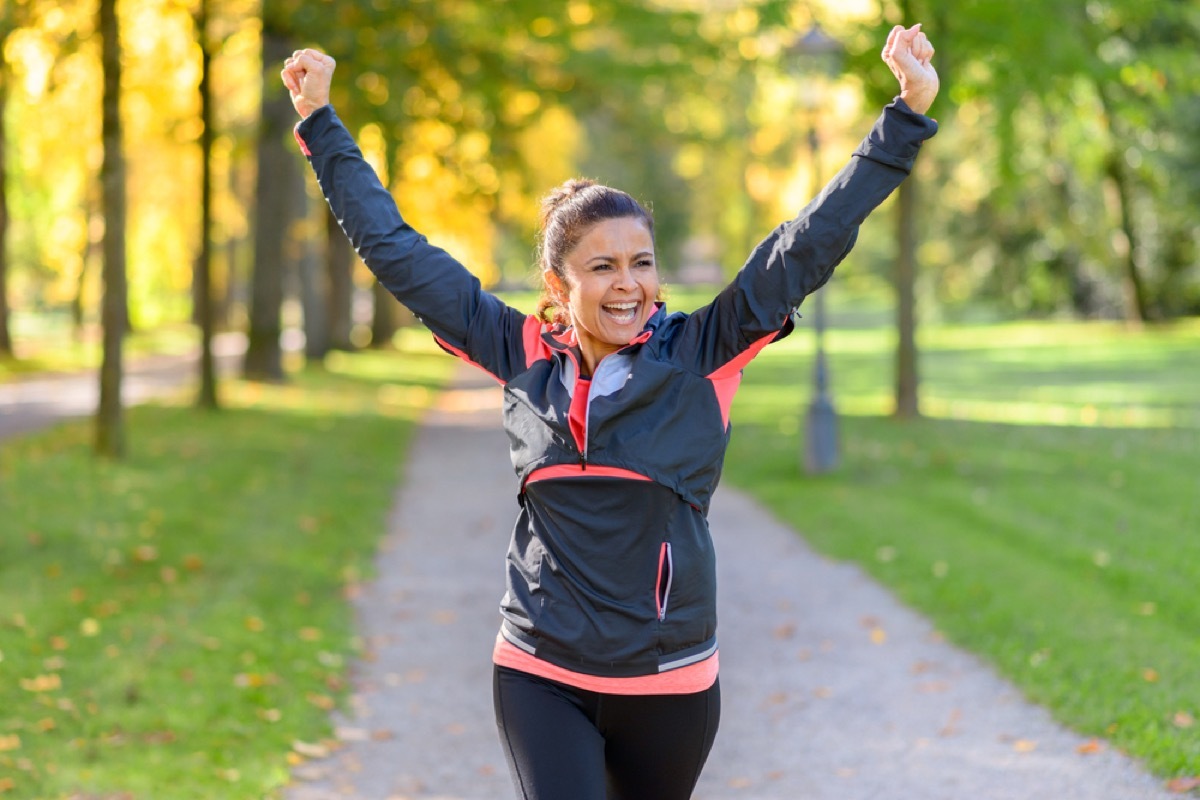 happy older woman jogging, look better after 40