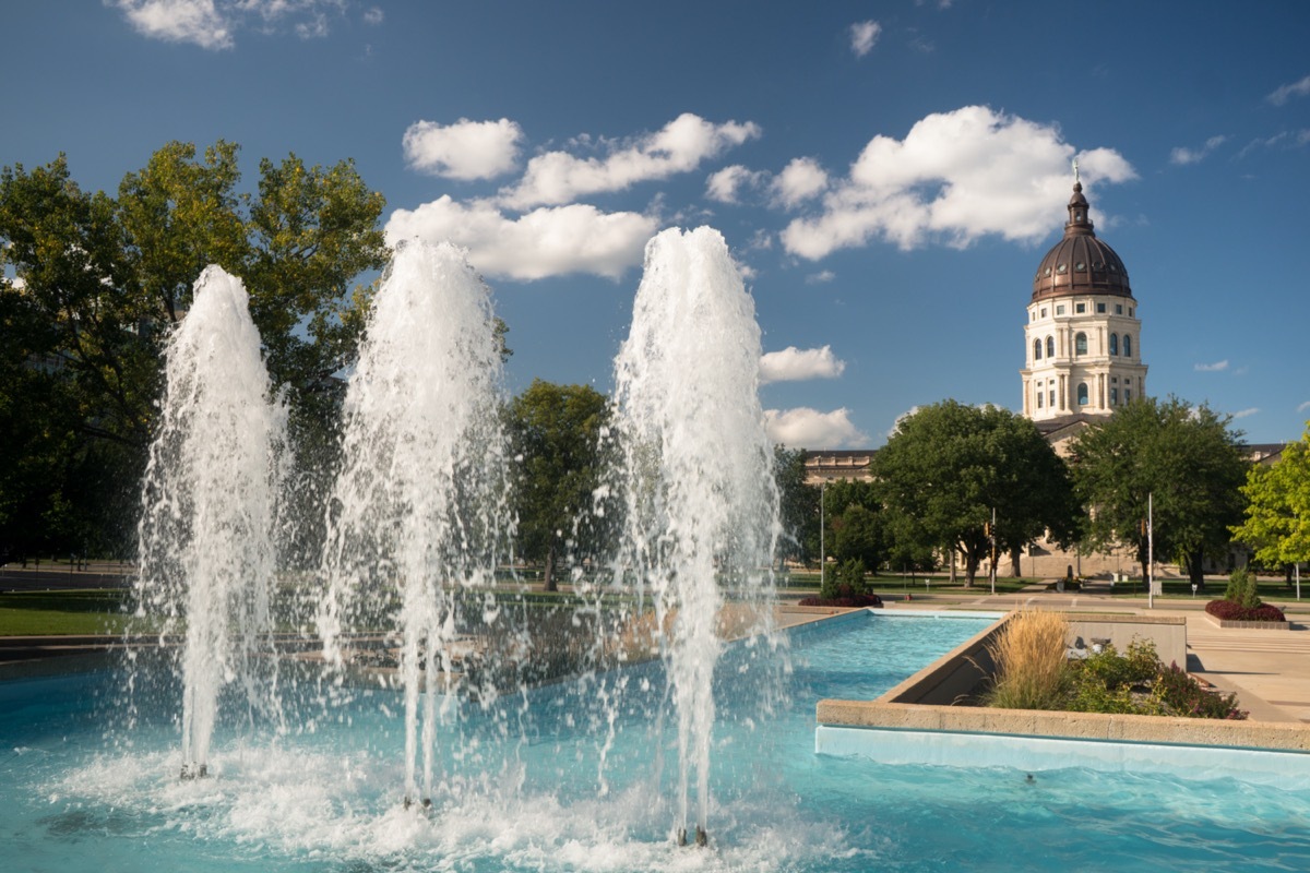 Soft clouds and blue skies appear over fountains and the capitol of Topeka, Kansas USA