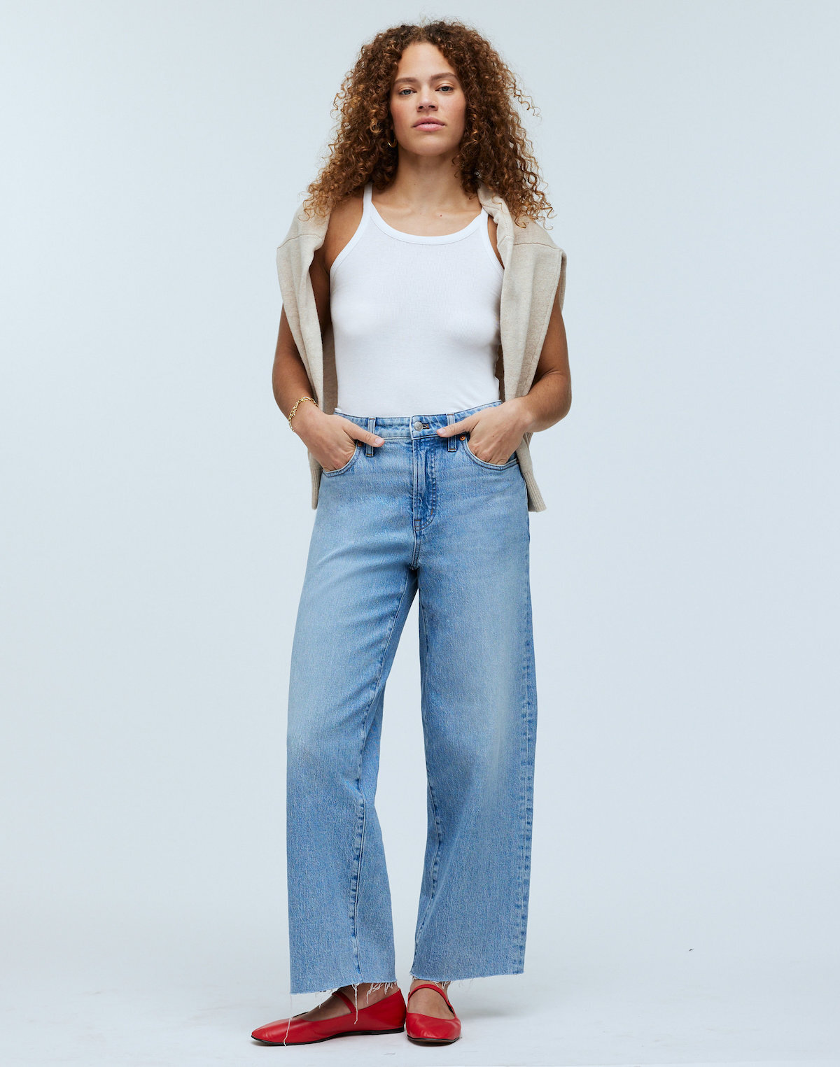 Model wearing Madewell jeans, a white tank, and red flats.