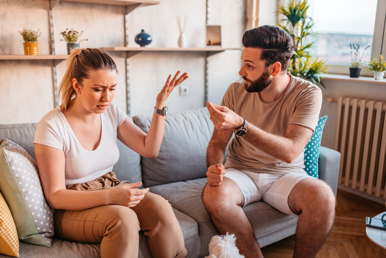 young couple fighting on the couch