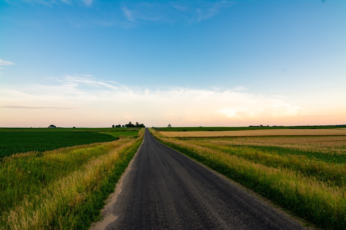 Open country road in rural Illinois as the sun sets