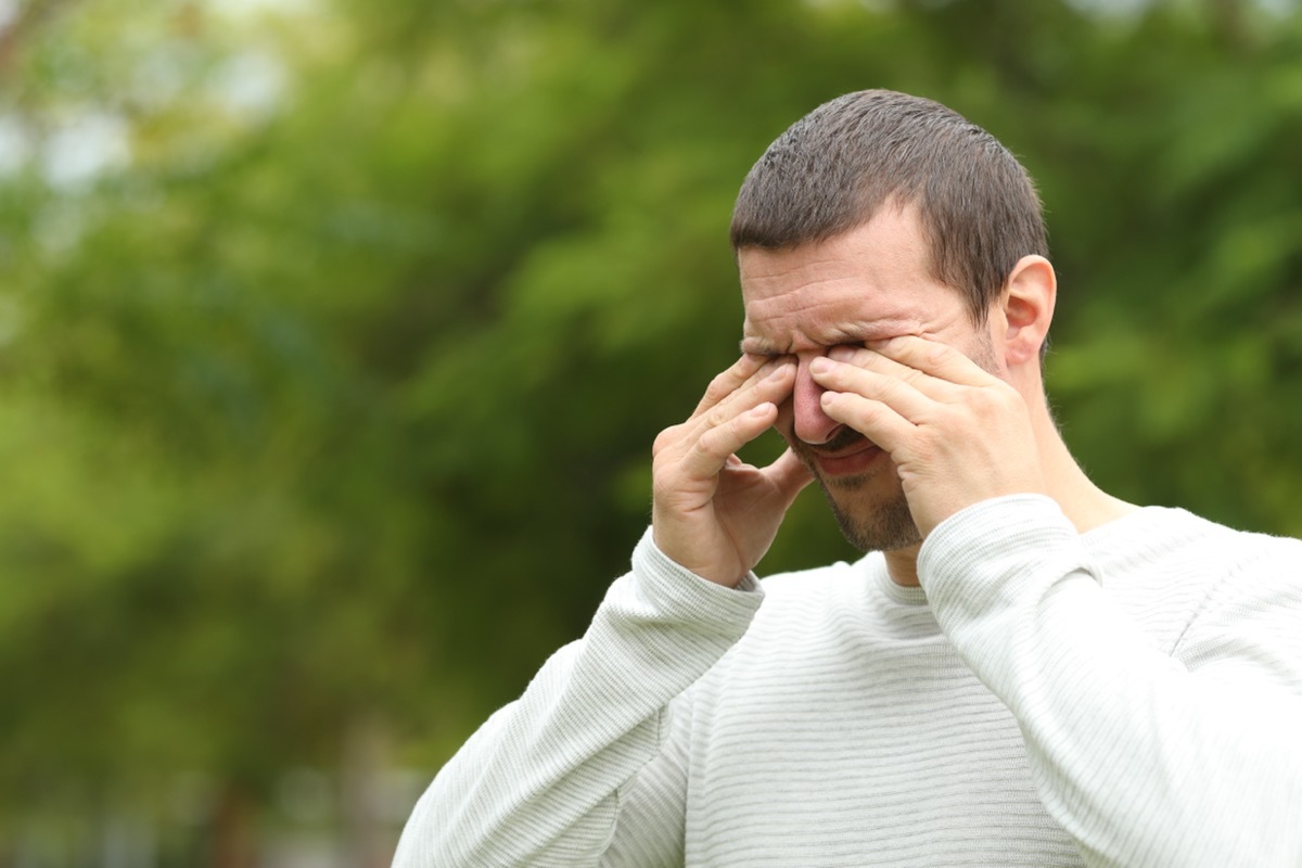 man scratching eyes