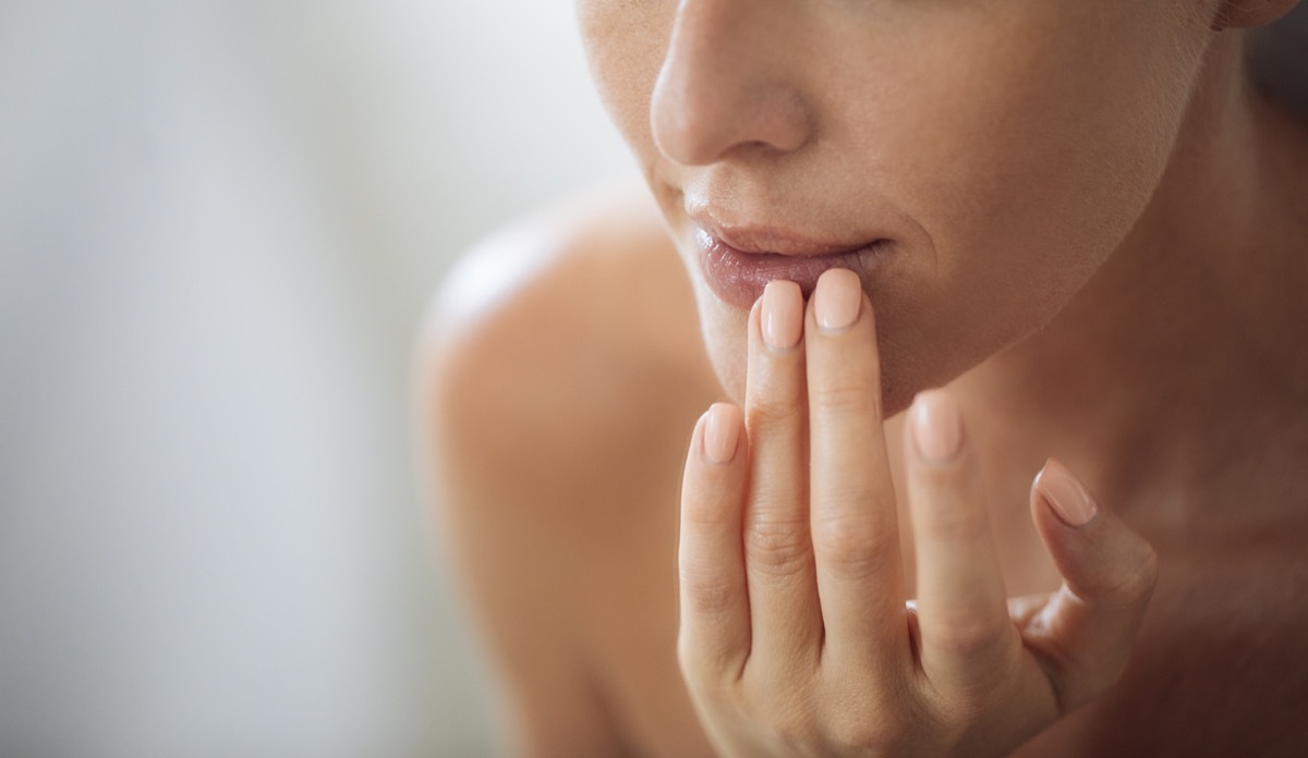 woman touching her lips