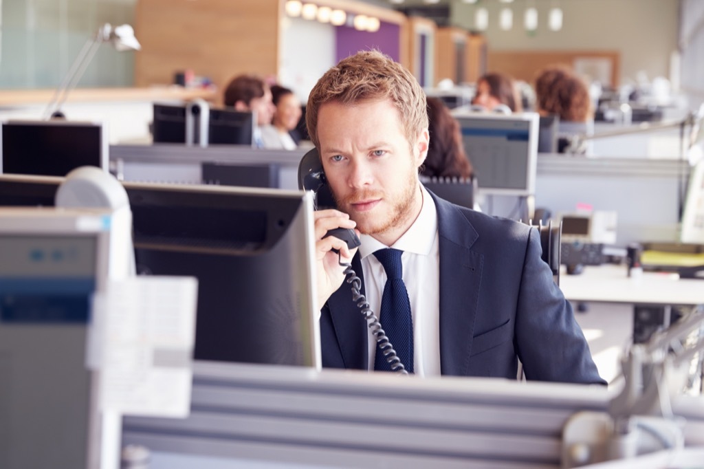 man talking on the phone at work