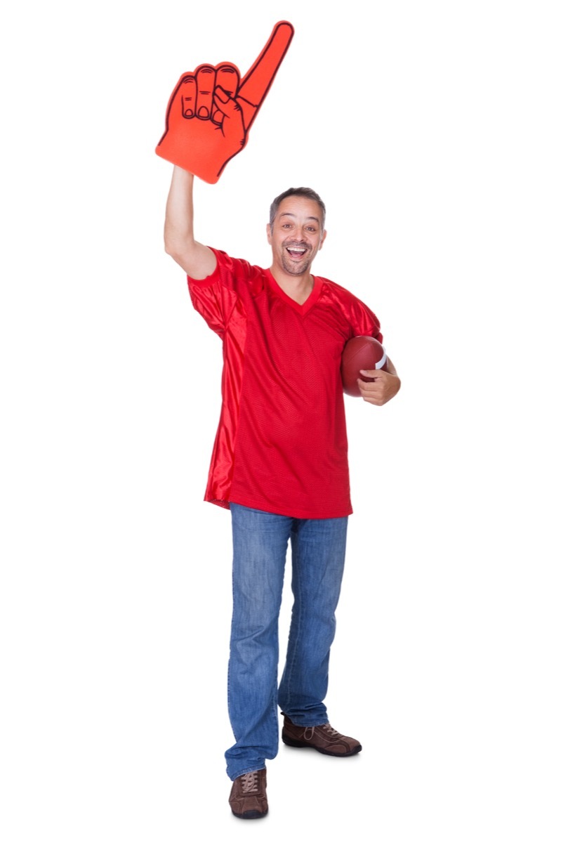 Man wearing a jersey holding a football