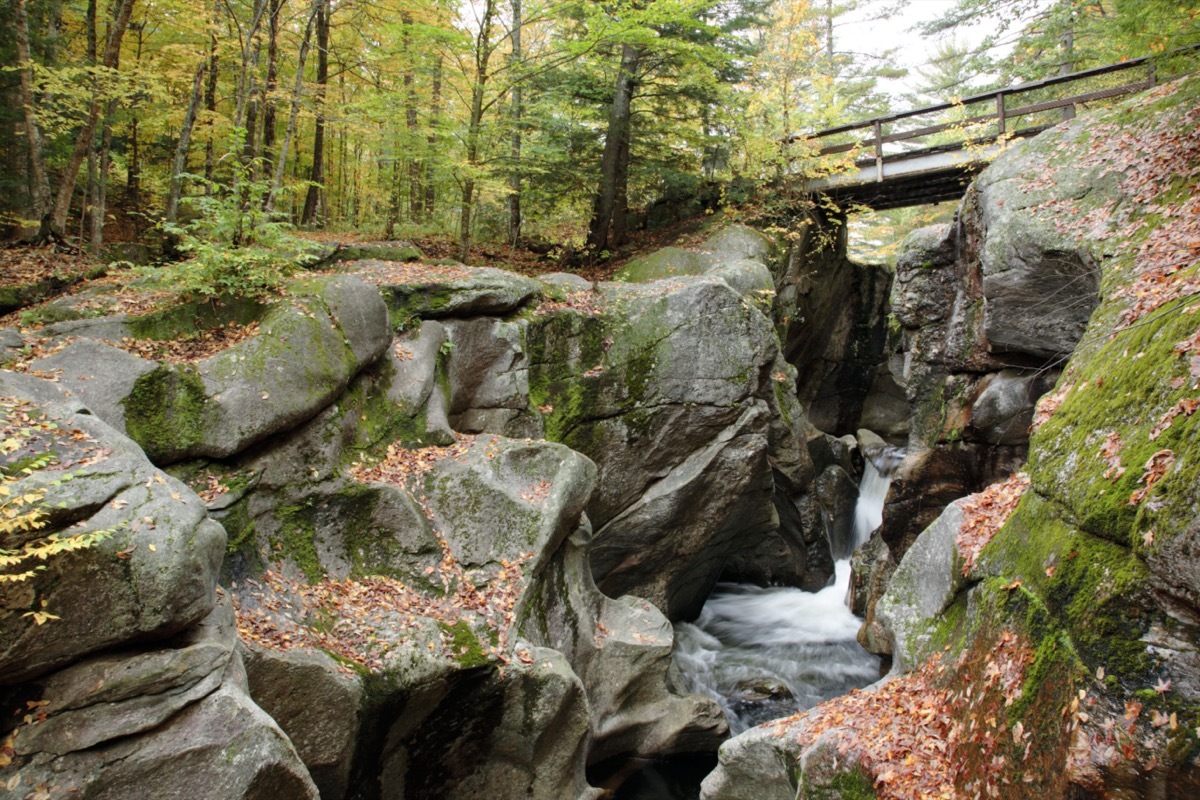 bridge over sculptured rocks and stream in New Hampshire