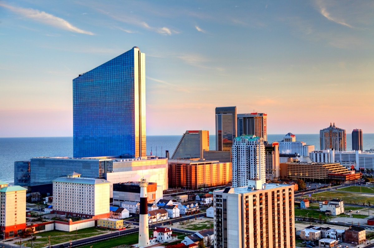 Atlantic City skyline including the Revel casino at dawn. Atlantic City located on the Jersey shore is a resort city on Absecon Island in Atlantic County, New Jersey. Atlantic City is known for its two mile long boardwalk, gambling casinos, great nightlife, beautiful beaches, and the Miss America Pageant.