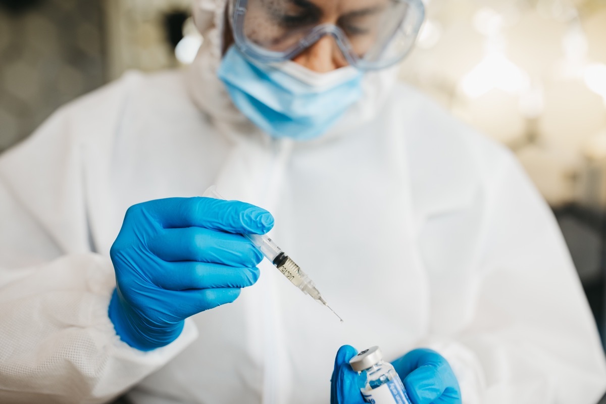 doctor or scientist in a protective suit, covid vaccine