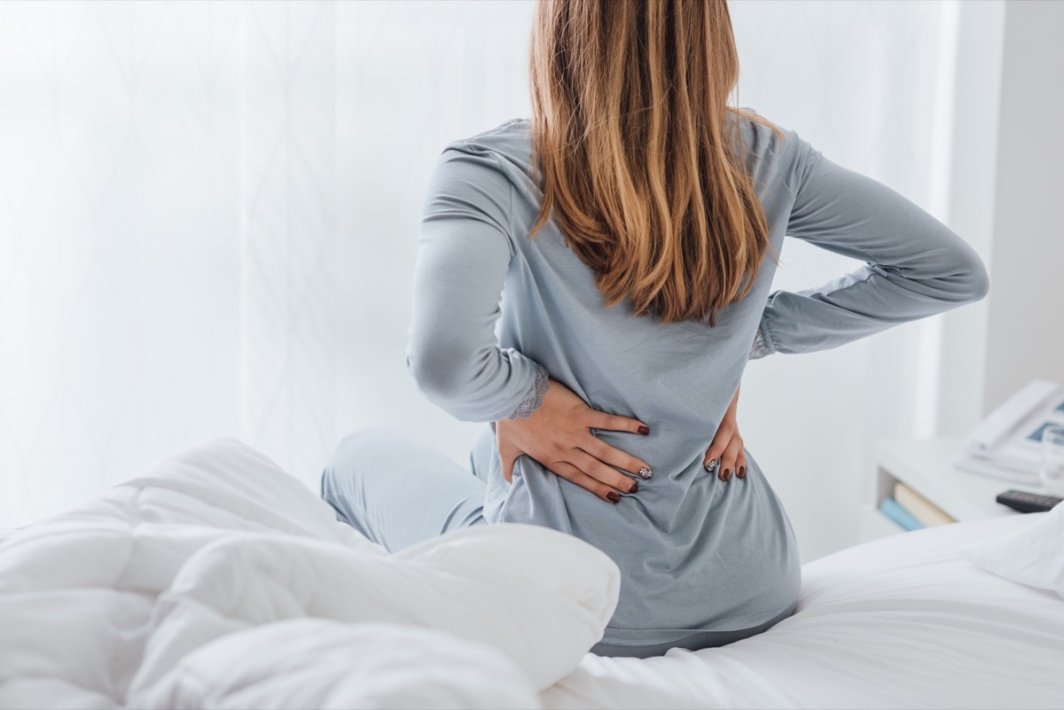 Woman with back pain from sleeping on her stomach