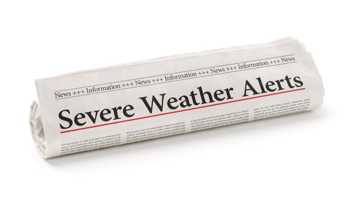 Rolled newspaper with the headline Severe Weather Alerts 