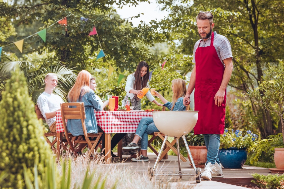 Man Grilling in Backyard