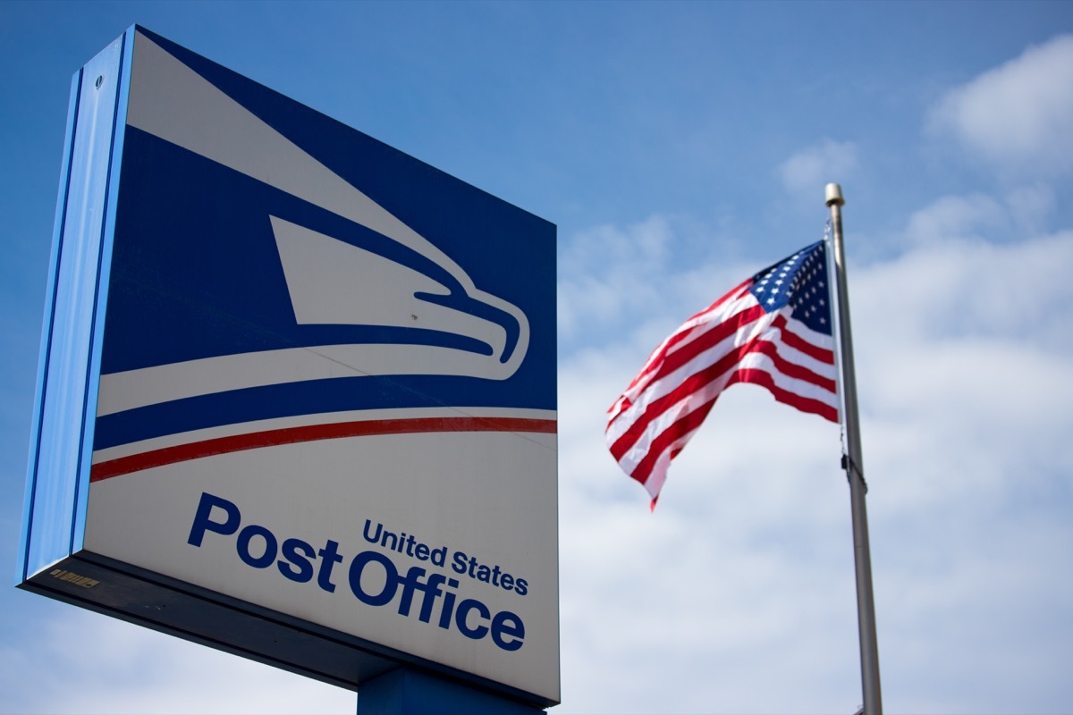 usps post office sign with American flag