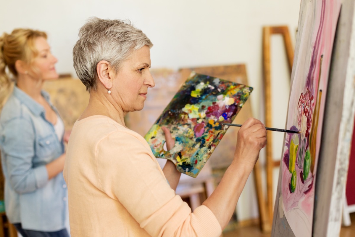 woman painting on canvas