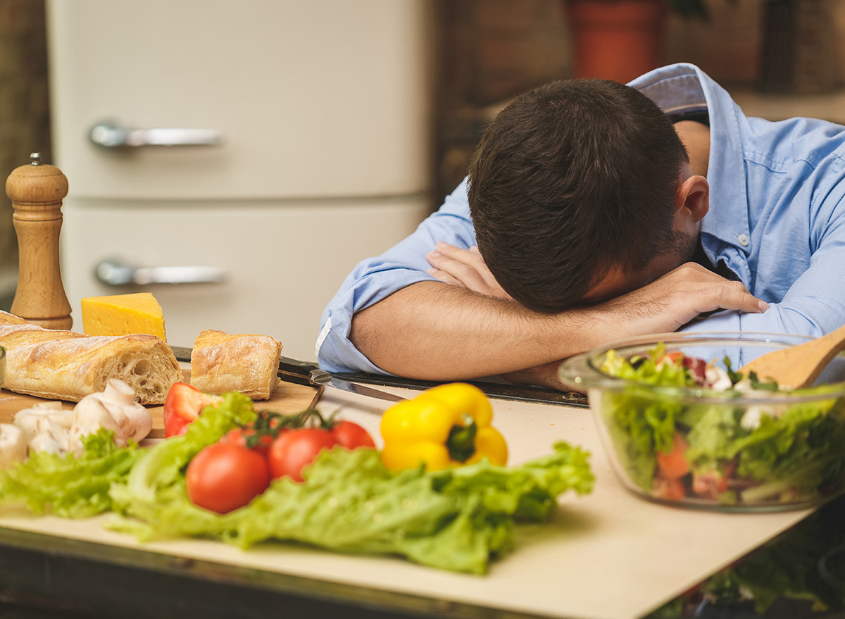 stressed man head down in kitchen